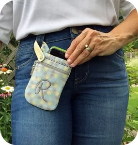 Our phone pouch secures around a belt loop keeping your phone handy
and your hands free.
The zippered pocket can hold cash, cards, etc.
It's made in your hoop and is fully lined with no exposed seams.