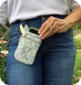 Our phone pouch secures around a belt loop keeping your phone handy
and your hands free.
The zippered pocket can hold cash, cards, etc.
It's made in your hoop and is fully lined with no exposed seams.